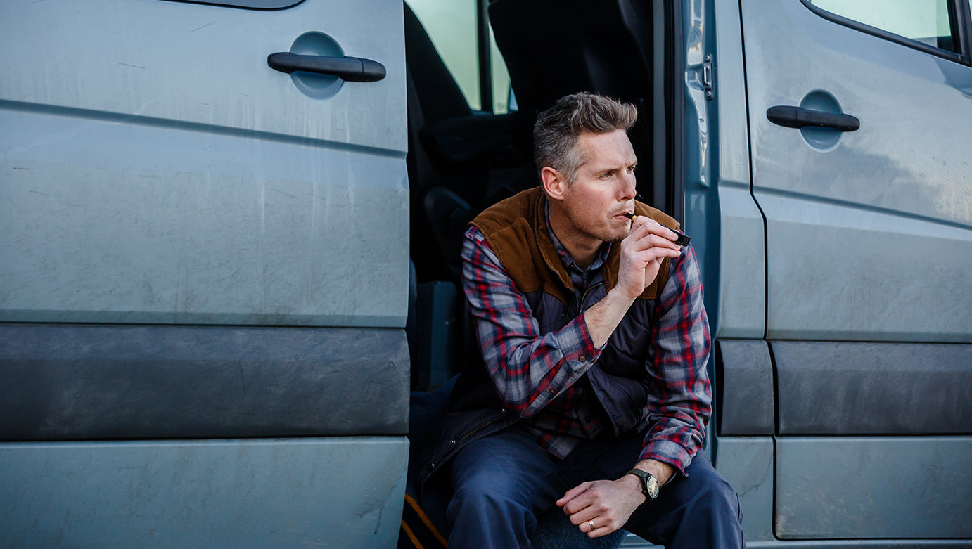 man in camper van with cbg vape